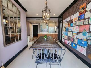 Artistic dining room with a collage of paintings and modern design