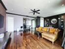 Spacious living room with leather sofa and hardwood floors