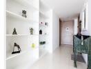 Bright and modern hallway with decorative shelving and stylish artifacts
