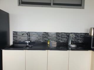 Modern kitchen with sleek design and black countertop
