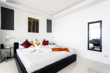 Elegantly decorated modern bedroom with stylish bedding and vibrant accents