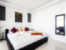 Elegantly decorated modern bedroom with stylish bedding and vibrant accents