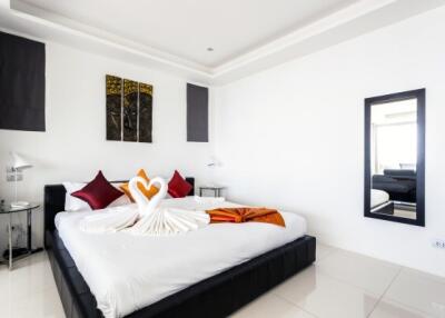 Elegantly decorated modern bedroom with stylish bedding and vibrant accents