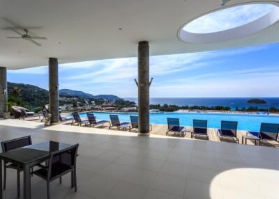 Spacious patio area with swimming pool and ocean view