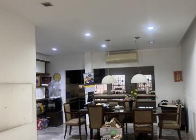 Spacious living area with dining setup and modern lighting