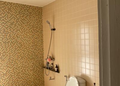 Brightly lit bathroom with detailed tile work