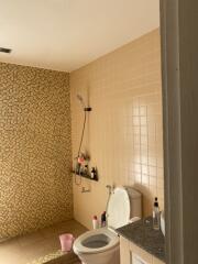 Brightly lit bathroom with detailed tile work