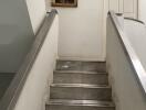 Marble staircase with white railing leading to upper floor in a home