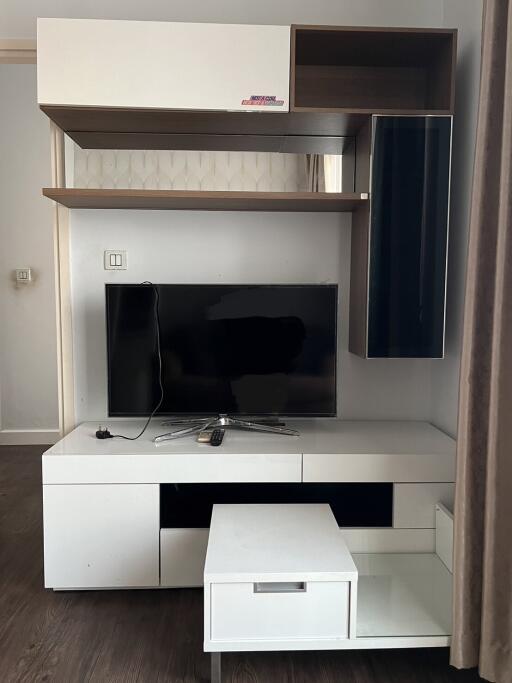 Modern living room with wall-mounted television and storage units