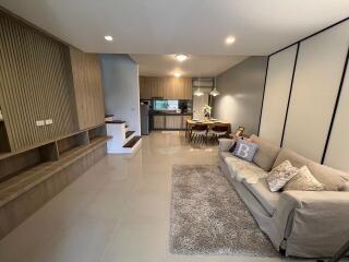 Modern open-plan living room with integrated kitchen and dining area