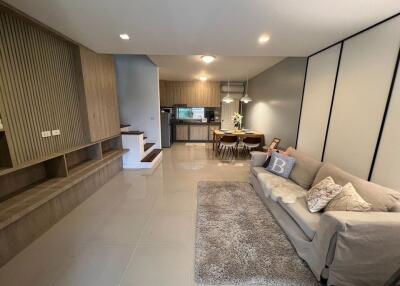 Modern open-plan living room with integrated kitchen and dining area