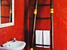 Vibrant red bathroom with decorative ladder and sink
