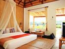 Bright and airy tropical bedroom with large windows and scenic view
