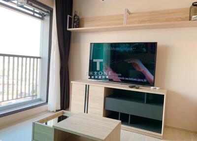 Modern living room with television and wooden shelves