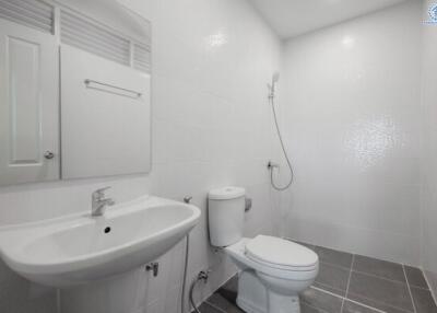 Clean and modern bathroom with white fixtures and tiled flooring