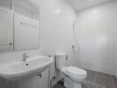 Clean and modern bathroom with white fixtures and tiled flooring