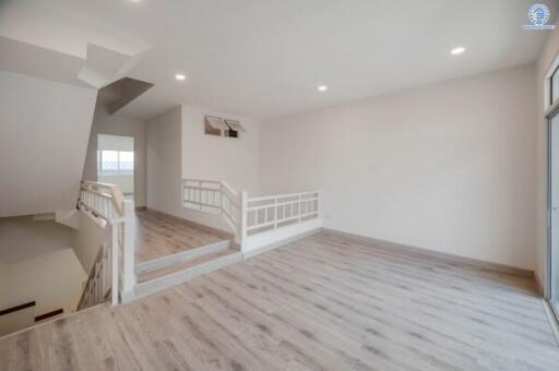 Spacious and bright upper-level hallway in modern home