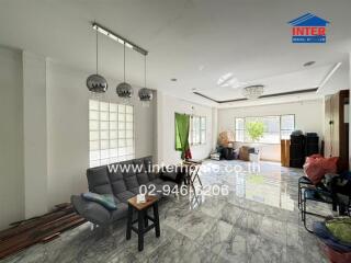 Spacious living room with natural lighting and modern furnishings