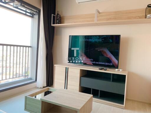 Modern living room with television and balcony access