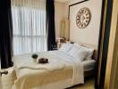 Elegantly furnished bedroom with large bed and stylish wall clock