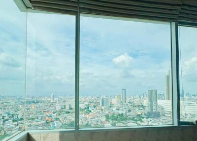 High-rise building interior with large windows overlooking the cityscape