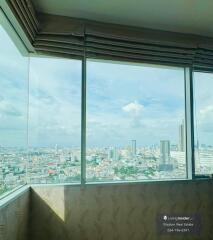 High-rise building interior with large windows overlooking the cityscape