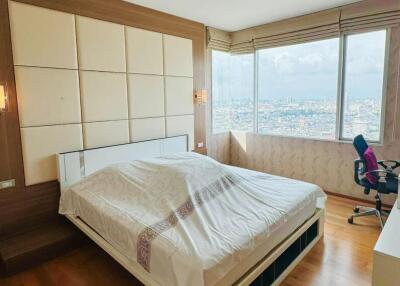 Spacious and well-lit bedroom with city view