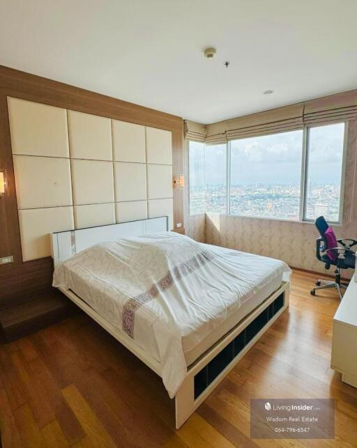 Spacious and well-lit bedroom with city view