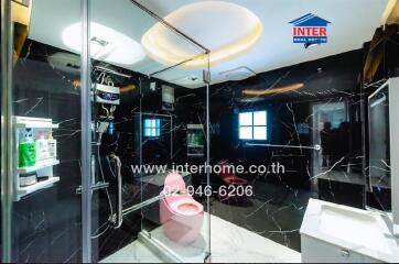 Modern bathroom with marble walls and stylish fixtures
