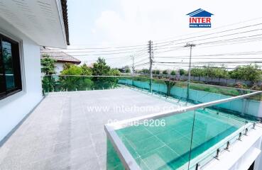 Spacious balcony with glass railing and scenic view