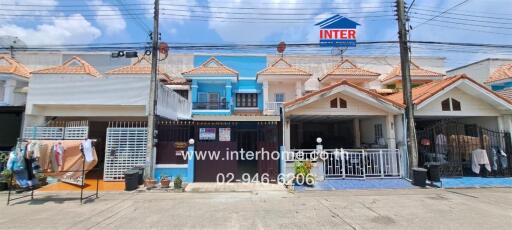 Exterior view of a residential twin house complex with clear blue sky