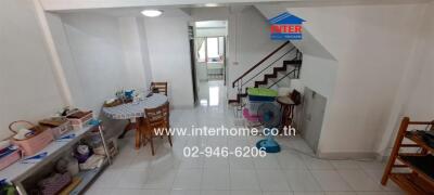 Spacious living room with dining area and staircase in a modern apartment