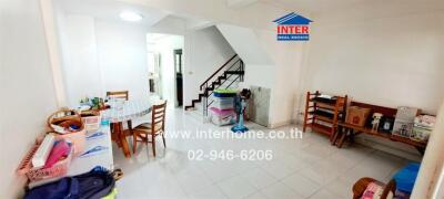 Spacious living room with dining area and staircase in a modern home