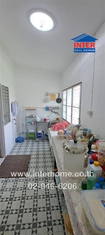 Spacious kitchen with tiled flooring and multiple counters