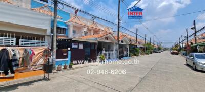 street view of residential area with townhouses and clear blue sky