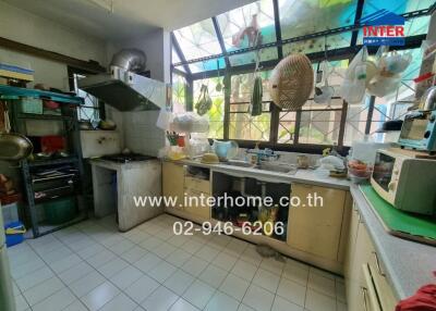 Spacious, well-lit kitchen with large windows and ample storage space