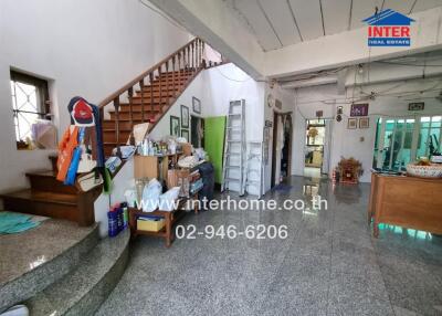 Spacious Living Area with Staircase and Storage Space