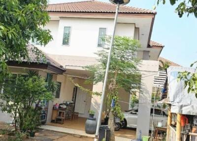 Exterior view of a residential house with surrounding greenery