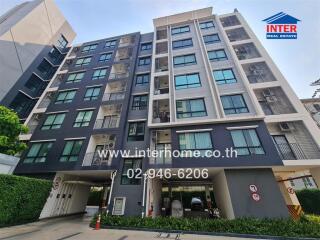 Modern residential building facade with balconies and parking