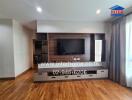 Spacious living room with modern entertainment unit and wooden flooring