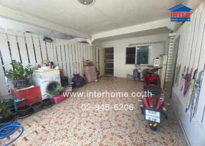 Spacious covered garage area with storage and motorcycle parking