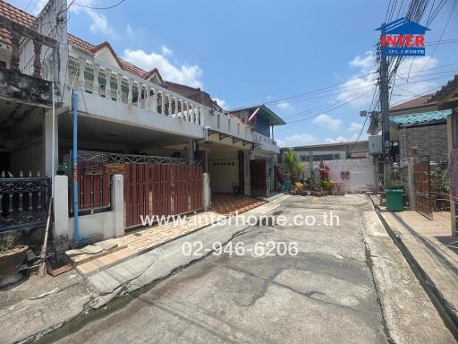 Spacious residential street view showing multiple houses with gated entrances