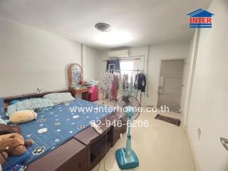 Spacious bedroom with large bed and wardrobe