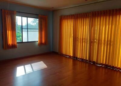 Spacious living room with ample natural light and vibrant curtains