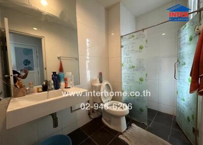 Spacious bathroom with large mirror and shower area