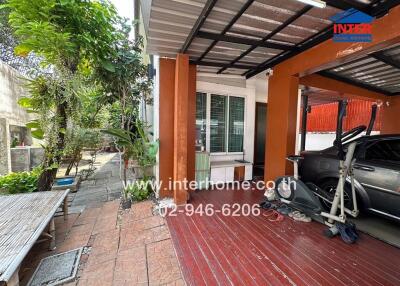 Covered patio and driveway area with parked car and bicycle