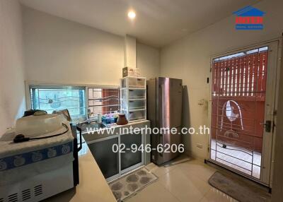 Compact kitchen with modern appliances and access to the balcony