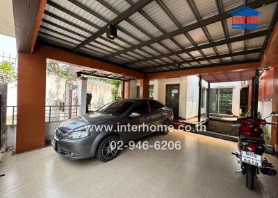 Spacious covered garage with one car and a motorcycle