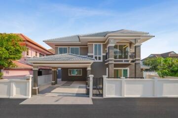 Elegant two-story house with balcony and large driveway