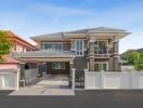 Elegant two-story house with balcony and large driveway